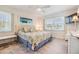 Bright bedroom featuring a queen bed with floral patterned bedding, and a ceiling fan at 387 S Mcmullen Booth Rd # 16, Clearwater, FL 33759
