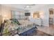 Brightly lit bedroom with queen bed, ceiling fan, and white dresser, offering a serene retreat at 387 S Mcmullen Booth Rd # 16, Clearwater, FL 33759