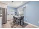 Light-filled dining area featuring a table with four chairs, with blue walls and modern decor at 387 S Mcmullen Booth Rd # 16, Clearwater, FL 33759
