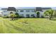Well-maintained two-story building with lush green lawn, mature palm trees, and manicured landscaping at 387 S Mcmullen Booth Rd # 16, Clearwater, FL 33759