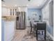 Kitchen and dining area featuring stainless steel refrigerator and dining table with seating for four at 387 S Mcmullen Booth Rd # 16, Clearwater, FL 33759