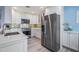 Well-lit kitchen featuring stainless steel appliances, white cabinetry, and a breakfast bar at 387 S Mcmullen Booth Rd # 16, Clearwater, FL 33759
