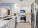 Stylish kitchen with stainless steel appliances, white cabinets, and an open breakfast bar at 387 S Mcmullen Booth Rd # 16, Clearwater, FL 33759