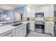 Bright and modern kitchen with white cabinets, quartz countertops, and stainless steel appliances at 387 S Mcmullen Booth Rd # 16, Clearwater, FL 33759
