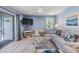 Comfortable living room with a desk, balcony, and beach-themed decor at 387 S Mcmullen Booth Rd # 16, Clearwater, FL 33759