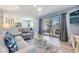 Open-concept living room with sliding doors to a balcony and modern furnishings at 387 S Mcmullen Booth Rd # 16, Clearwater, FL 33759