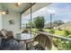Relaxing screened patio with a table and chairs, offering serene views of the landscaped surroundings at 387 S Mcmullen Booth Rd # 16, Clearwater, FL 33759
