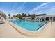 Beautiful community pool with clear blue water, poolside lounge chairs, and tropical landscaping at 387 S Mcmullen Booth Rd # 16, Clearwater, FL 33759
