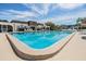 Community pool offers a refreshing escape, with comfortable lounge chairs, shady umbrellas and lush greenery at 387 S Mcmullen Booth Rd # 16, Clearwater, FL 33759