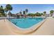 Large, inviting pool featuring clear water, poolside seating and umbrellas, perfect for relaxation at 387 S Mcmullen Booth Rd # 16, Clearwater, FL 33759