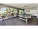 Spacious rec room with ping pong table, comfortable seating, and bright windows overlooking the grounds at 387 S Mcmullen Booth Rd # 16, Clearwater, FL 33759