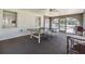 Open-concept rec room featuring a ping pong table, ceiling fan, and views of the lush exterior at 387 S Mcmullen Booth Rd # 16, Clearwater, FL 33759