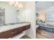 Well-lit vanity area with granite countertop and dark wood cabinets, leading into bedroom area at 387 S Mcmullen Booth Rd # 16, Clearwater, FL 33759