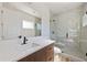 Bathroom with glass shower enclosure, modern vanity, and plenty of natural light at 4604 W Euclid Ave, Tampa, FL 33629