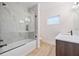 Modern bathroom features a luxurious marble-walled shower over tub and modern vanity at 4604 W Euclid Ave, Tampa, FL 33629