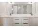 Bathroom showcasing dual sinks, modern cabinetry, and sleek fixtures with a large mirror at 4604 W Euclid Ave, Tampa, FL 33629