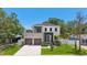 Contemporary two-story home with manicured lawn, two-car garage, and modern balcony at 4604 W Euclid Ave, Tampa, FL 33629