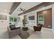 Open concept living room featuring stone fireplace, ceiling fan, recessed lights and modern finishes at 4604 W Euclid Ave, Tampa, FL 33629