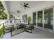 Inviting covered outdoor living area with a built-in kitchen, ceiling fans, and comfortable seating at 4604 W Euclid Ave, Tampa, FL 33629