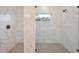 Modern bathroom with a luxurious walk-in shower featuring floor to ceiling marble and modern fixtures at 4604 W Euclid Ave, Tampa, FL 33629