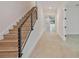 Modern wooden staircase featuring black cable railing and recessed lights at 4604 W Euclid Ave, Tampa, FL 33629