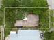 Aerial view of a cozy home surrounded by lush trees, showcasing its location and roof at 501 74Th N Ave, St Petersburg, FL 33702