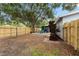Large fenced backyard with mature trees, gravel, and a patio area perfect for relaxing and entertaining at 501 74Th N Ave, St Petersburg, FL 33702