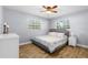 This bedroom is bright and airy with a comfortable queen-size bed and wood look flooring at 501 74Th N Ave, St Petersburg, FL 33702