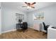 This bedroom has wood-look flooring, a ceiling fan, and space for a desk at 501 74Th N Ave, St Petersburg, FL 33702