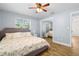 Cozy bedroom with a floral bedspread, ceiling fan, wood floors and a mirrored closet at 501 74Th N Ave, St Petersburg, FL 33702