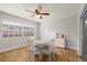 Cozy dining area with wood floors, a round table, and a window providing natural light at 501 74Th N Ave, St Petersburg, FL 33702