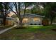 Charming home featuring a manicured lawn and a quaint front porch, enhanced by mature trees and an American flag at 501 74Th N Ave, St Petersburg, FL 33702