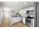 Updated kitchen featuring stainless steel appliances, white cabinets, and granite countertops at 501 74Th N Ave, St Petersburg, FL 33702
