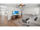 Bright living room with wood floors, a plush sectional sofa, and a flat screen TV at 501 74Th N Ave, St Petersburg, FL 33702