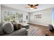 Bright living room with wood floors, a plush sectional sofa, and a large window providing ample natural light at 501 74Th N Ave, St Petersburg, FL 33702