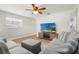Bright living room features a ceiling fan, wood-look flooring and comfortable seating at 501 74Th N Ave, St Petersburg, FL 33702