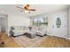 Bright living room with wood floors, a plush sectional sofa, and a large window providing ample natural light at 501 74Th N Ave, St Petersburg, FL 33702