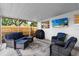 Inviting screened patio with comfortable seating, outdoor grill, and a TV for entertaining at 501 74Th N Ave, St Petersburg, FL 33702