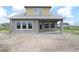 Newly constructed home with large windows, door to the backyard, and an inviting outdoor space at 5028 Chapel Row Ave, Apollo Beach, FL 33572