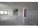 Spacious unfinished living room showing stairs and entryways to other parts of the home at 5028 Chapel Row Ave, Apollo Beach, FL 33572