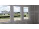 New construction featuring a wall of energy-efficient windows with neighborhood views at 5028 Chapel Row Ave, Apollo Beach, FL 33572