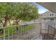 Balcony view of lush greenery and building exterior, complete with modern chair at 507 S Willow Ave, Tampa, FL 33606