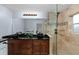 Luxurious bathroom with double vanity, granite countertop, glass shower, and custom tile work at 507 S Willow Ave, Tampa, FL 33606