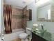 Bright bathroom featuring a glass vessel sink, unique fixtures, and a shower-tub combination at 507 S Willow Ave, Tampa, FL 33606