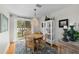 Elegant dining area with modern chandelier, hardwood floors, and light-filled balcony access at 507 S Willow Ave, Tampa, FL 33606
