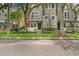 Exterior of charming two-story townhome with landscaped front yard and mature trees at 507 S Willow Ave, Tampa, FL 33606