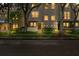 Charming townhome featuring well-manicured landscaping and warm, inviting lighting at dusk at 507 S Willow Ave, Tampa, FL 33606