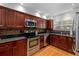 Well-equipped kitchen with stainless steel appliances, cherry cabinets, and granite countertops at 507 S Willow Ave, Tampa, FL 33606