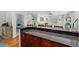 Granite countertop with dark wood cabinets for kitchen bar seating area at 507 S Willow Ave, Tampa, FL 33606