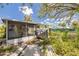 View of the backyard featuring a screened porch and wooden deck at 508 2Nd St, Indian Rocks Beach, FL 33785